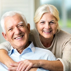 Older couple enjoying long-term benefits of dental implants
