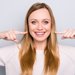 woman pointing to her teeth