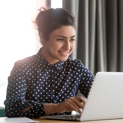 person researching on their laptop