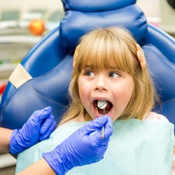 girl blonde hair undergoing dental checkup