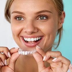 Woman placing Invisalign tray