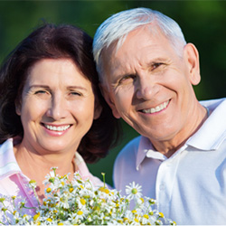 Smiling older man and woman outdoors