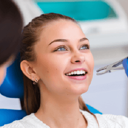 Woman having tooth removed