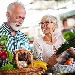 senior man and woman shopping for vegetables 
