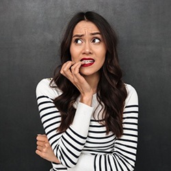 woman nervously biting her fingernails 