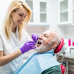 dental hygienist cleaning a patient’s teeth 