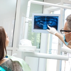 dentist showing a patient their X-rays