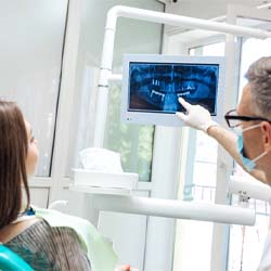 dentist showing a patient their X-rays