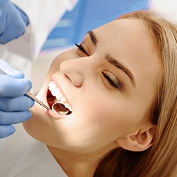 Woman receiving oral cancer screening