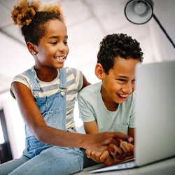 children without cavities in Pearland playing on a computer together