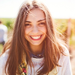 teen girl smiling outside
