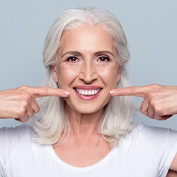 Woman pointing to her white smile