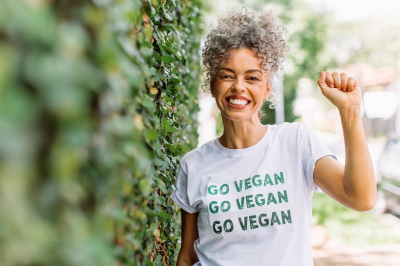 smiling woman wearing vegan shirt