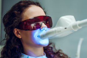 Woman having professional teeth whitening